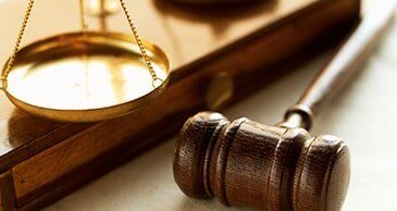 Weights balancing scales of justice with gavel - Law Services in New Brunswick, NJ