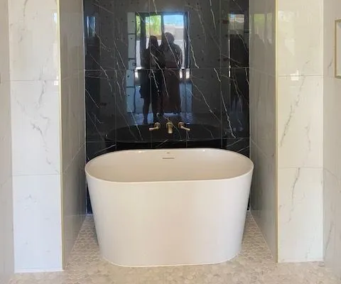 There is a bathtub in the middle of the bathroom.