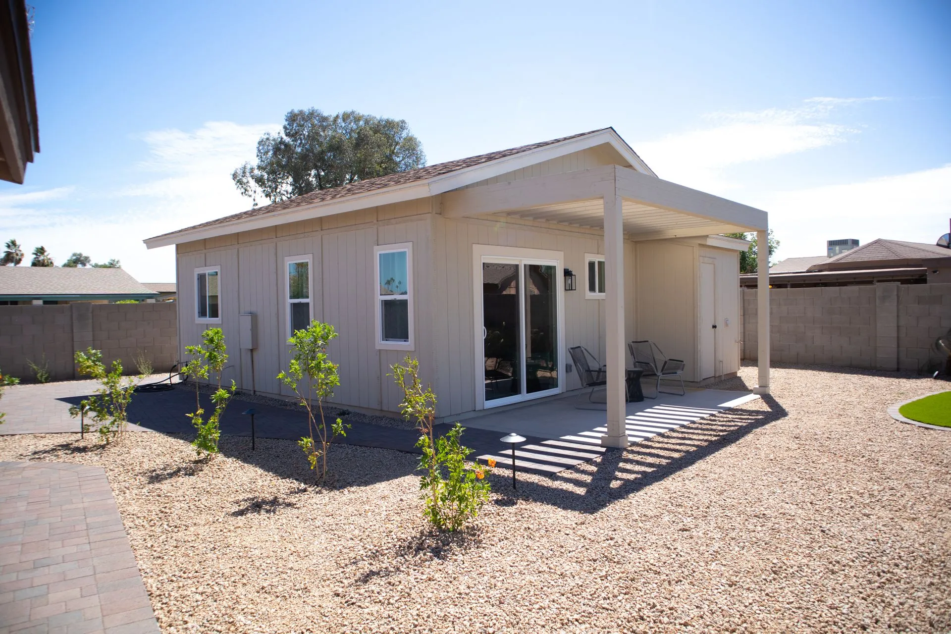 A small house with a covered porch and sliding glass doors
