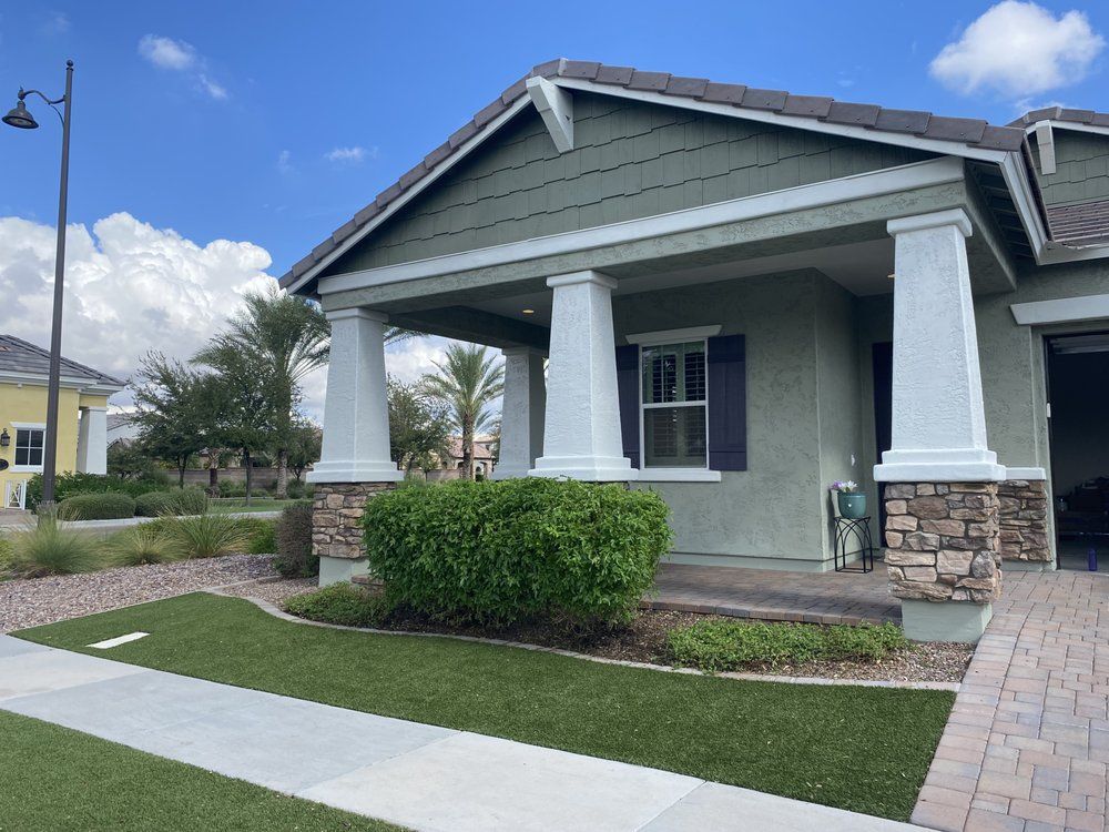 A house with a porch and a walkway in front of it