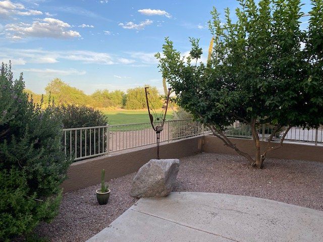 There is a large rock in the middle of the yard.