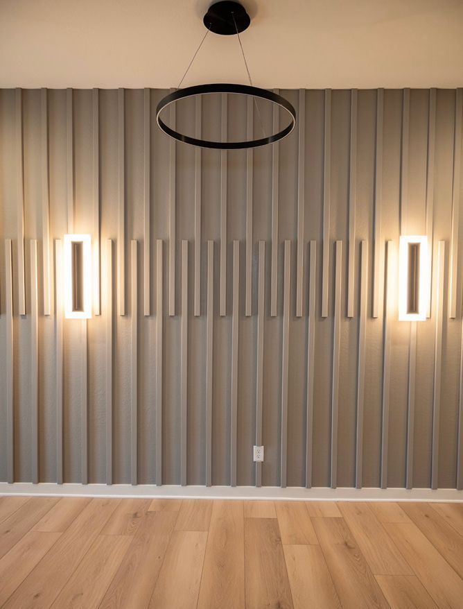 A room with a wooden floor and a ceiling light hanging from the ceiling.