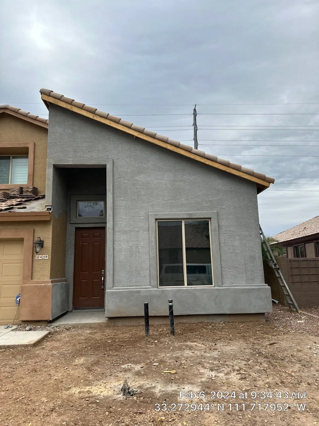 A small house with a slanted roof is being built.