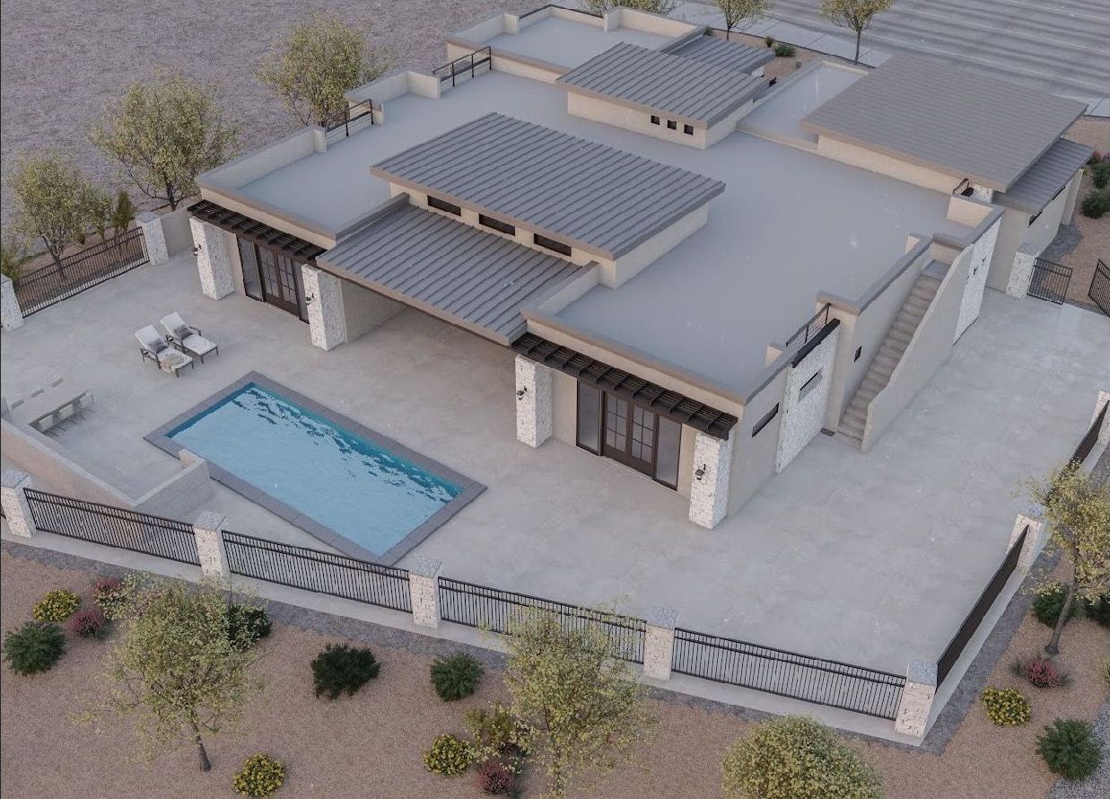 An aerial view of a house with a pool in the middle of the desert.