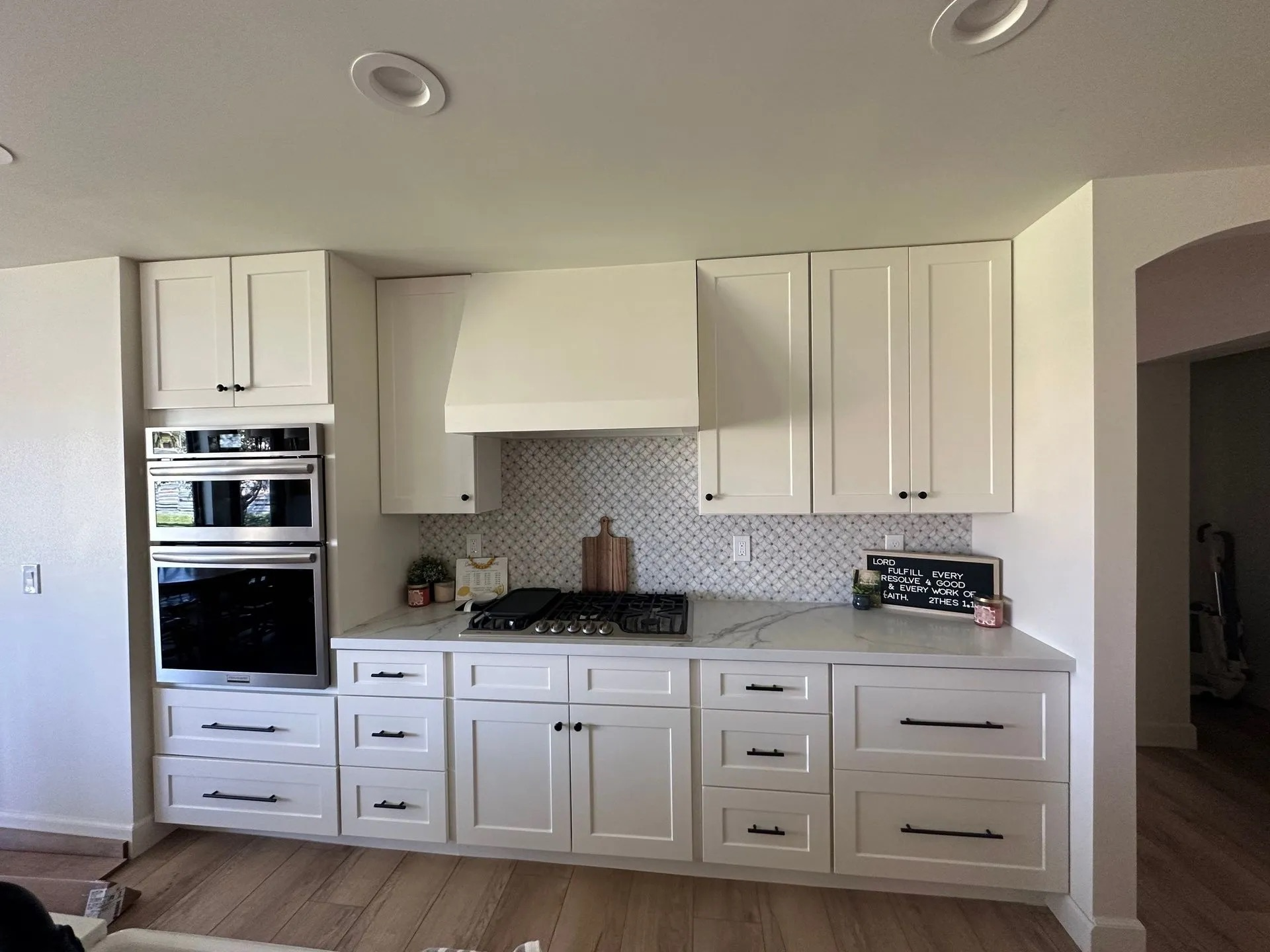 A kitchen with white cabinets and stainless steel appliances.