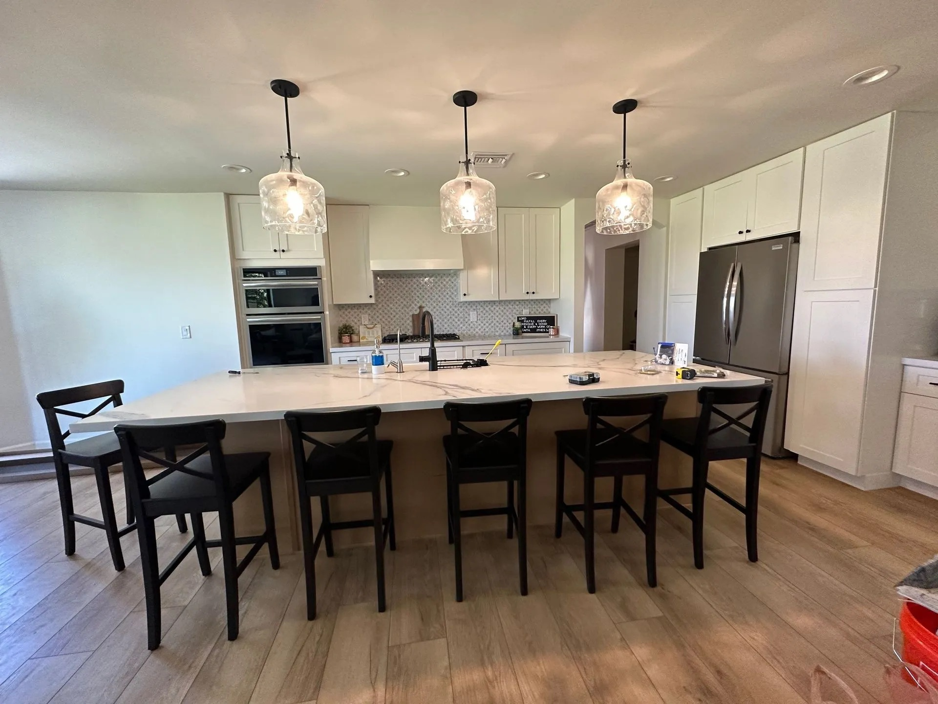 A kitchen with a large island and stools.