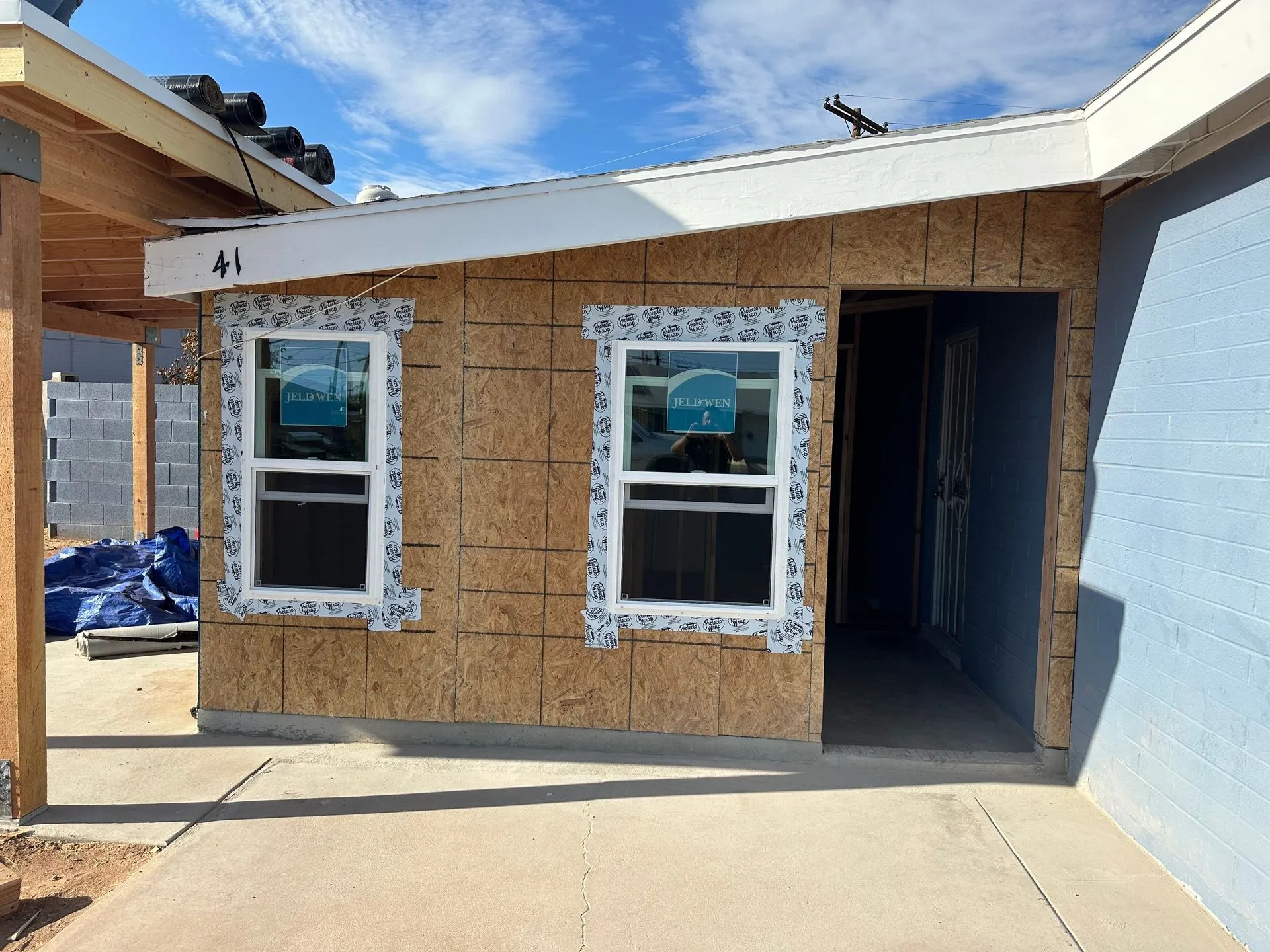 A house that is being built with a lot of windows