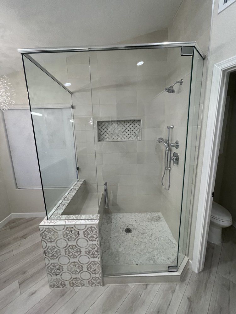 A bathroom with a walk in shower and a toilet.