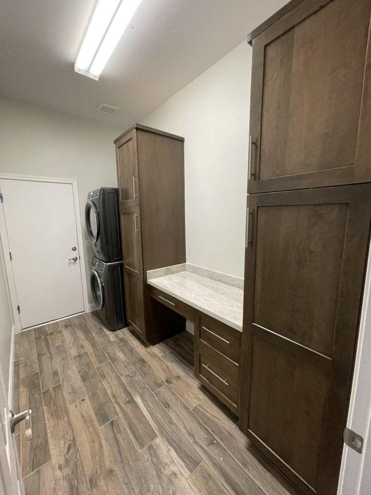 A laundry room with a washer and dryer stacked on top of each other.