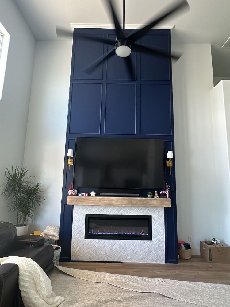 A living room with a fireplace and a flat screen tv.