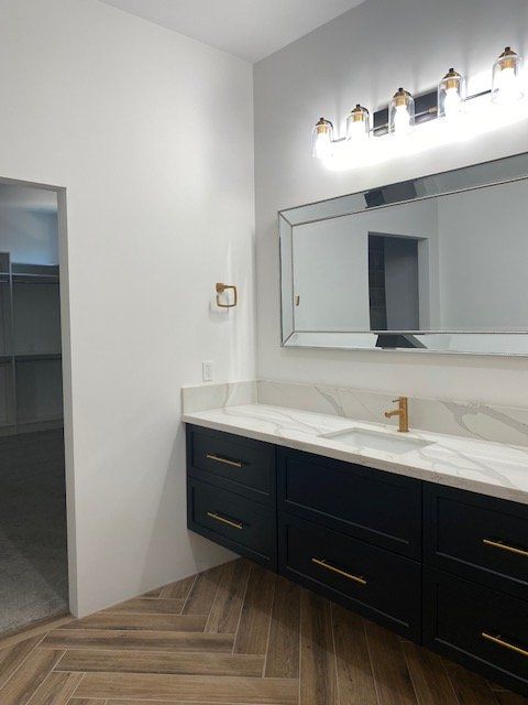 A bathroom with two sinks and a large mirror