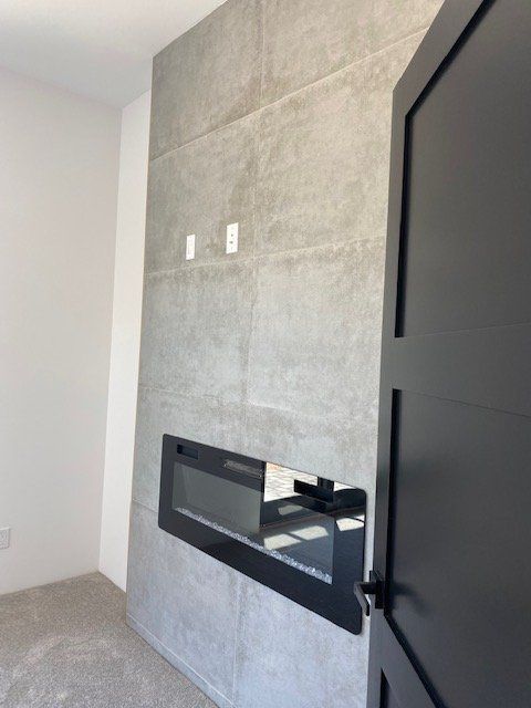 A room with a fireplace and a black door