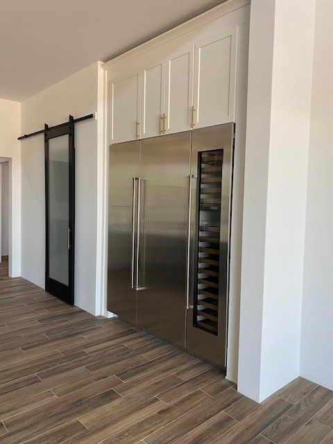 A stainless steel refrigerator with a wine cooler inside of it