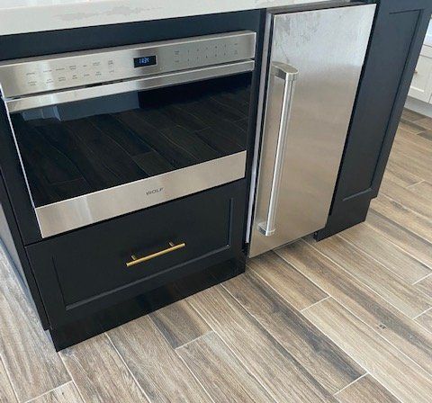 A kitchen with a stainless steel refrigerator and a stainless steel oven.
