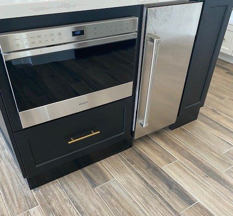 A kitchen with a stainless steel refrigerator and a stainless steel oven.