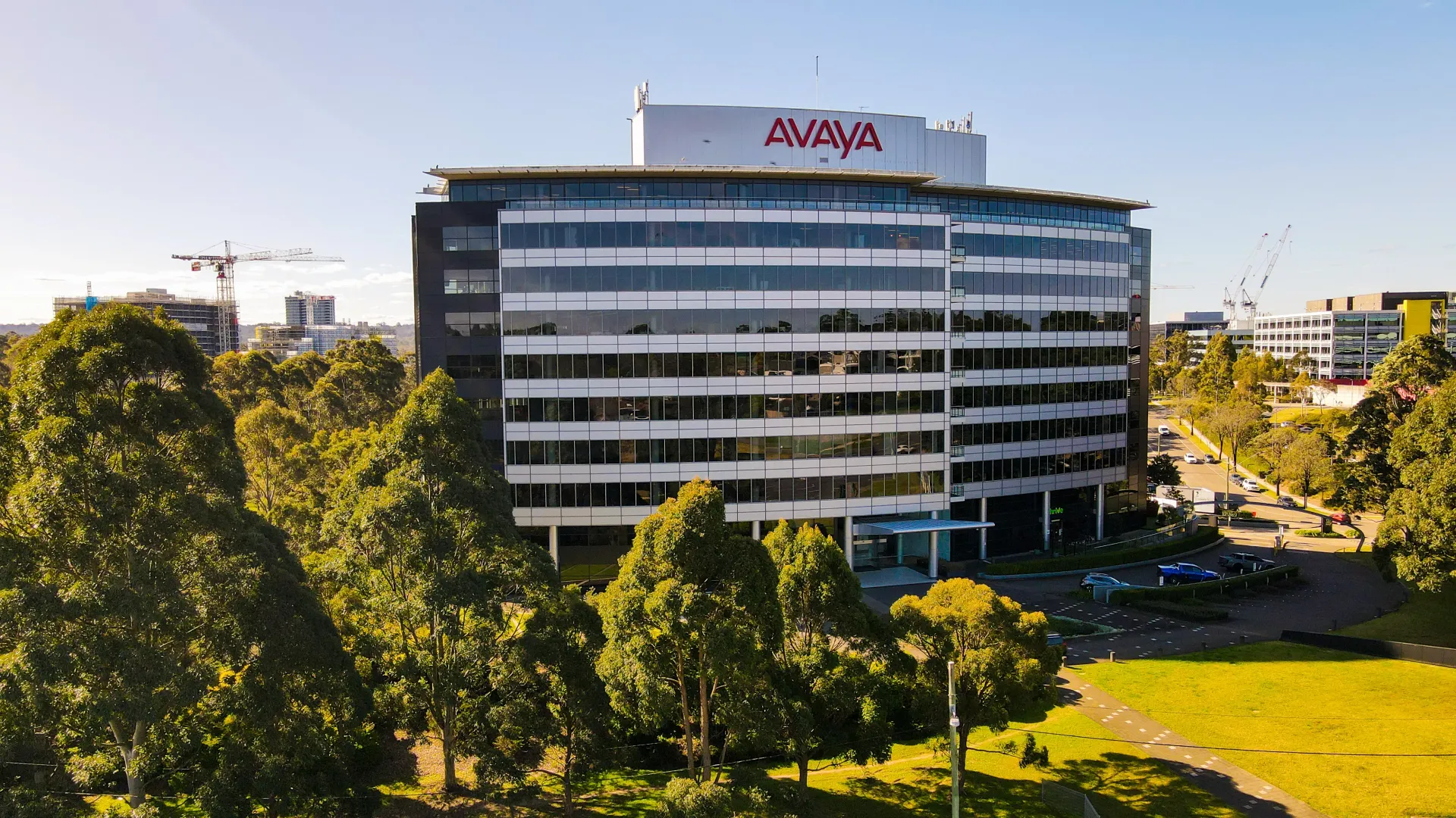 an aerial view of an avaya building surrounded by trees