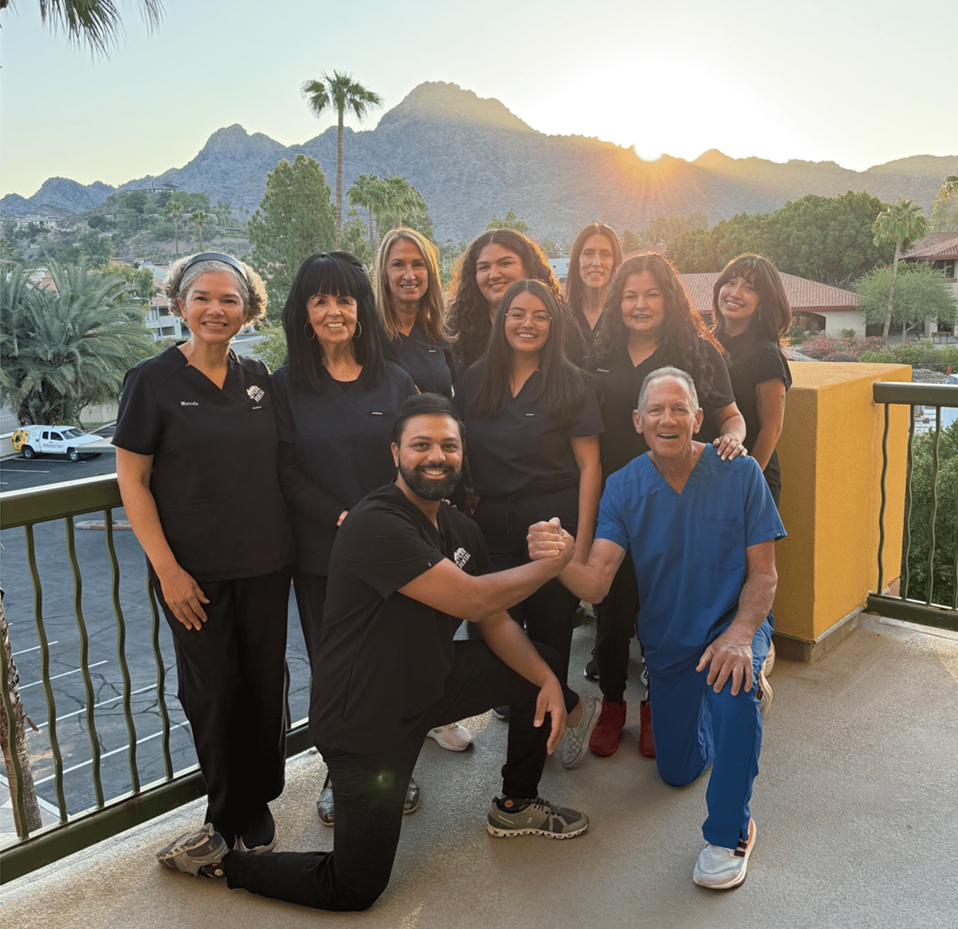 A group of people in scrubs are posing for a picture.