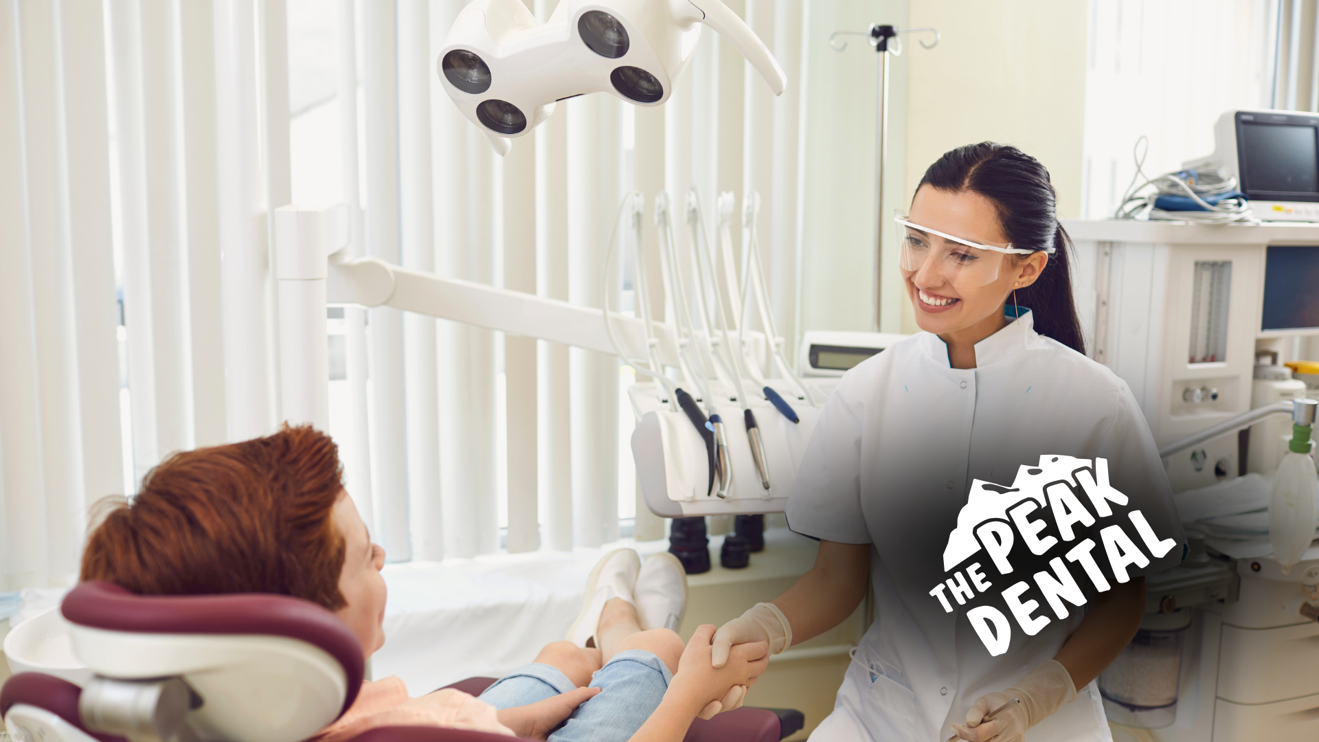 A woman is talking to a child in a dental chair.