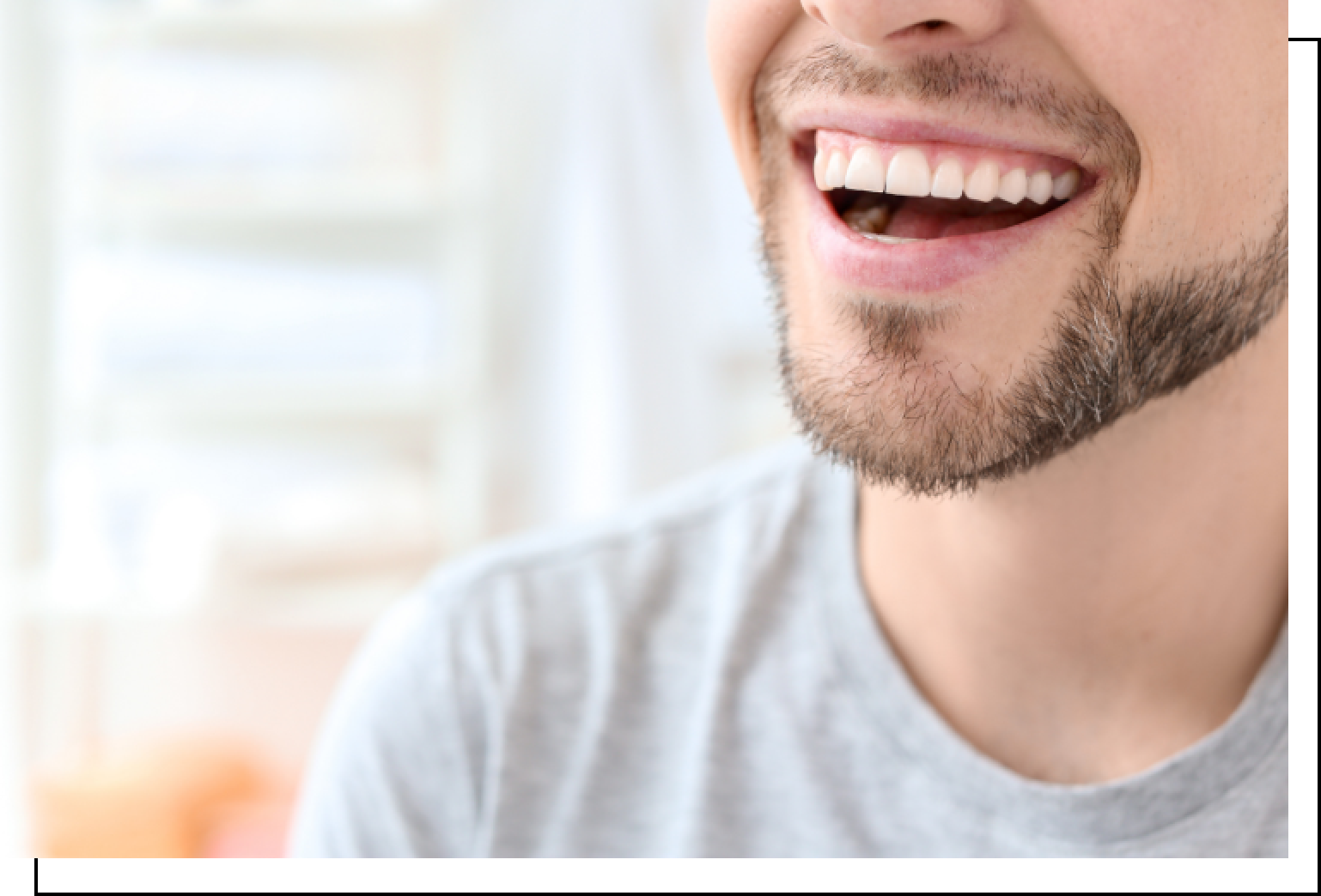 A man with a beard is smiling with his mouth open.