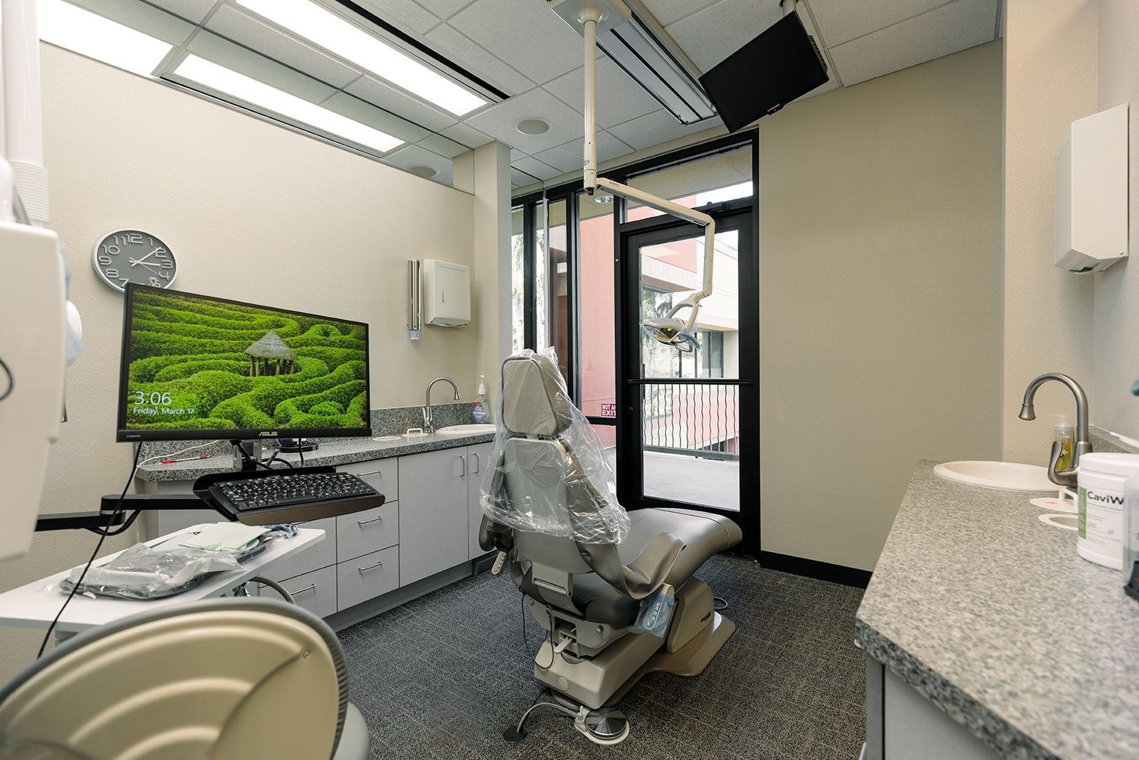 A dental office with a dental chair and a monitor