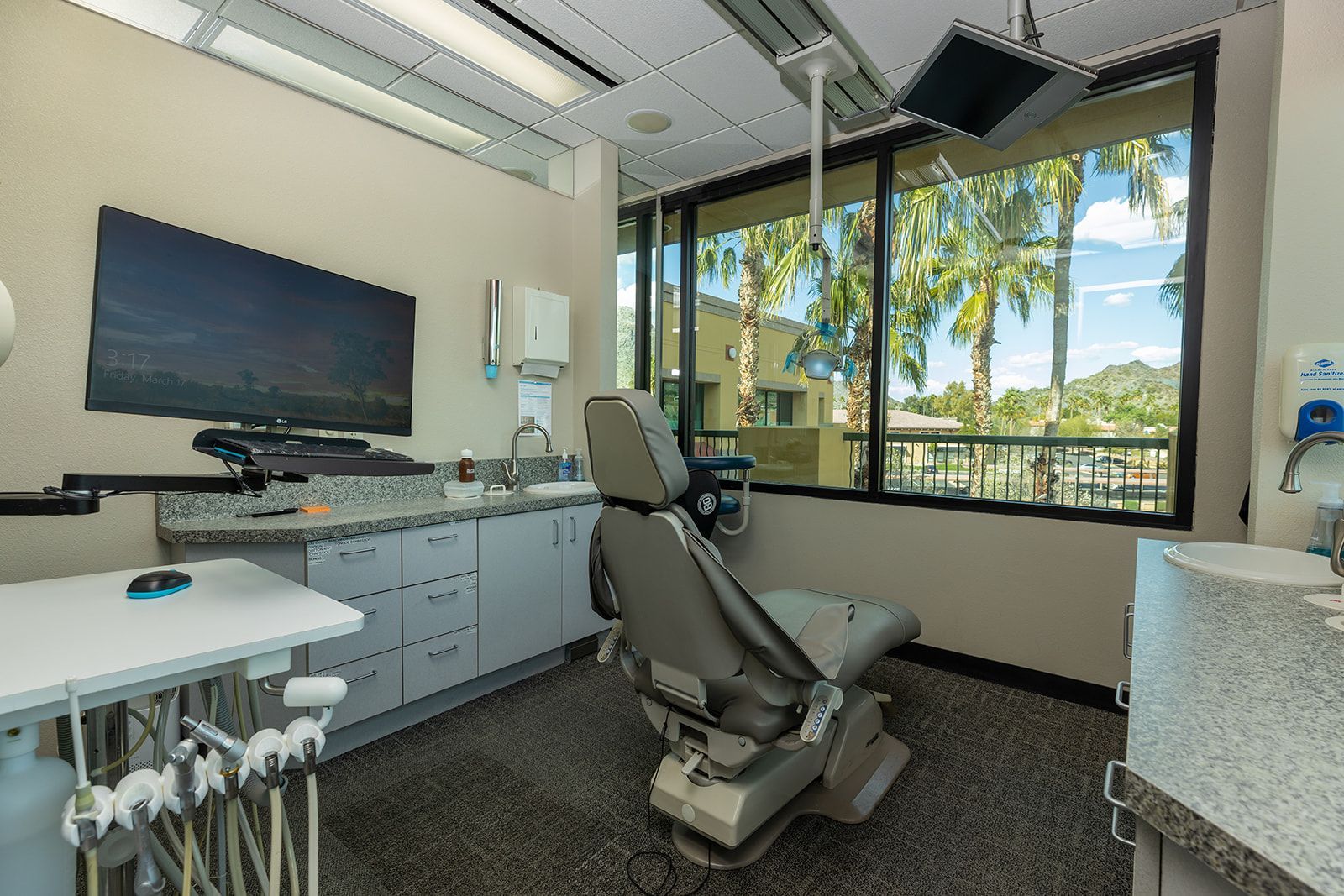 A dental office with a dental chair and a large window.