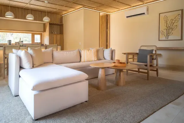 Sala de estar del Hotel Aimarawa en Punta Bolívar con diseño moderno, muebles en tonos claros y ambiente acogedor.