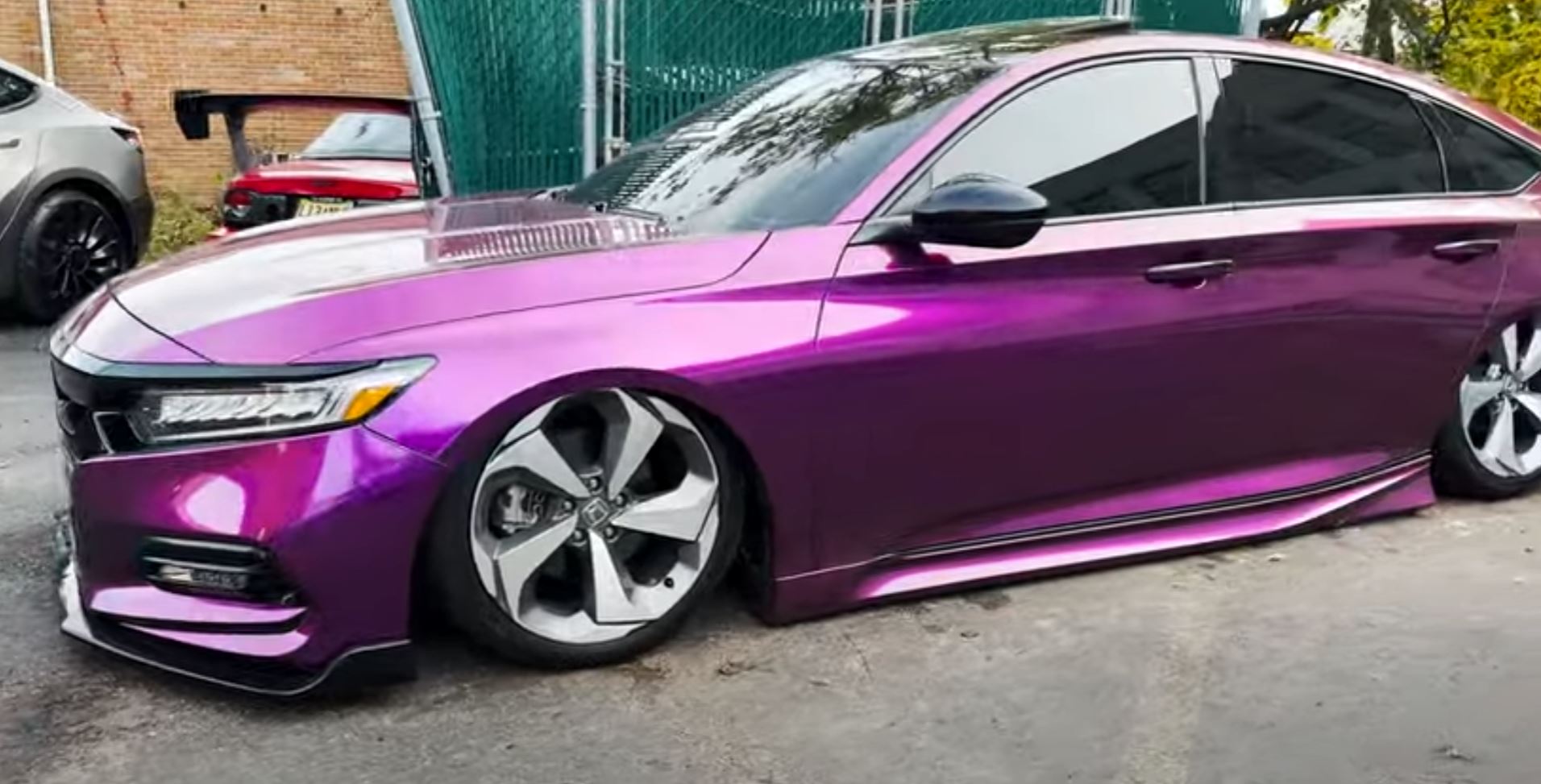 this is a honda civic wrapped in a satin purple photographed from the side