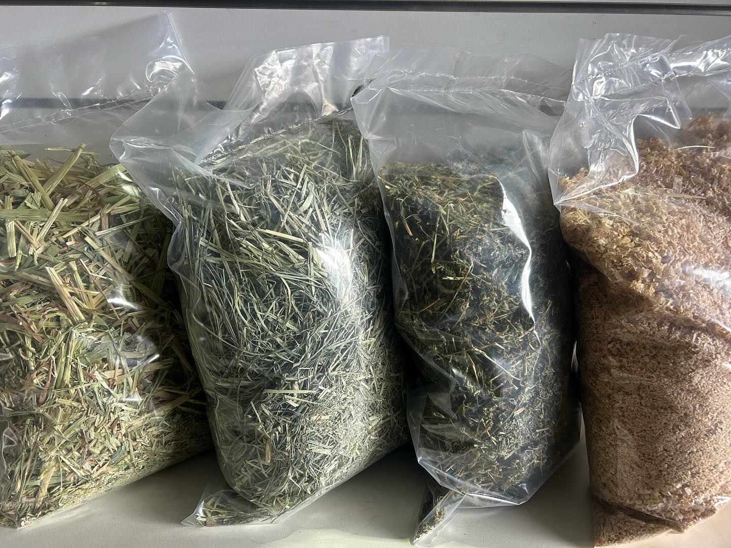 Four Clear Plastic Bags Containing Different Types of Dried Animal Feed — North Coast Stock Feeds in Lennox Head, NSW