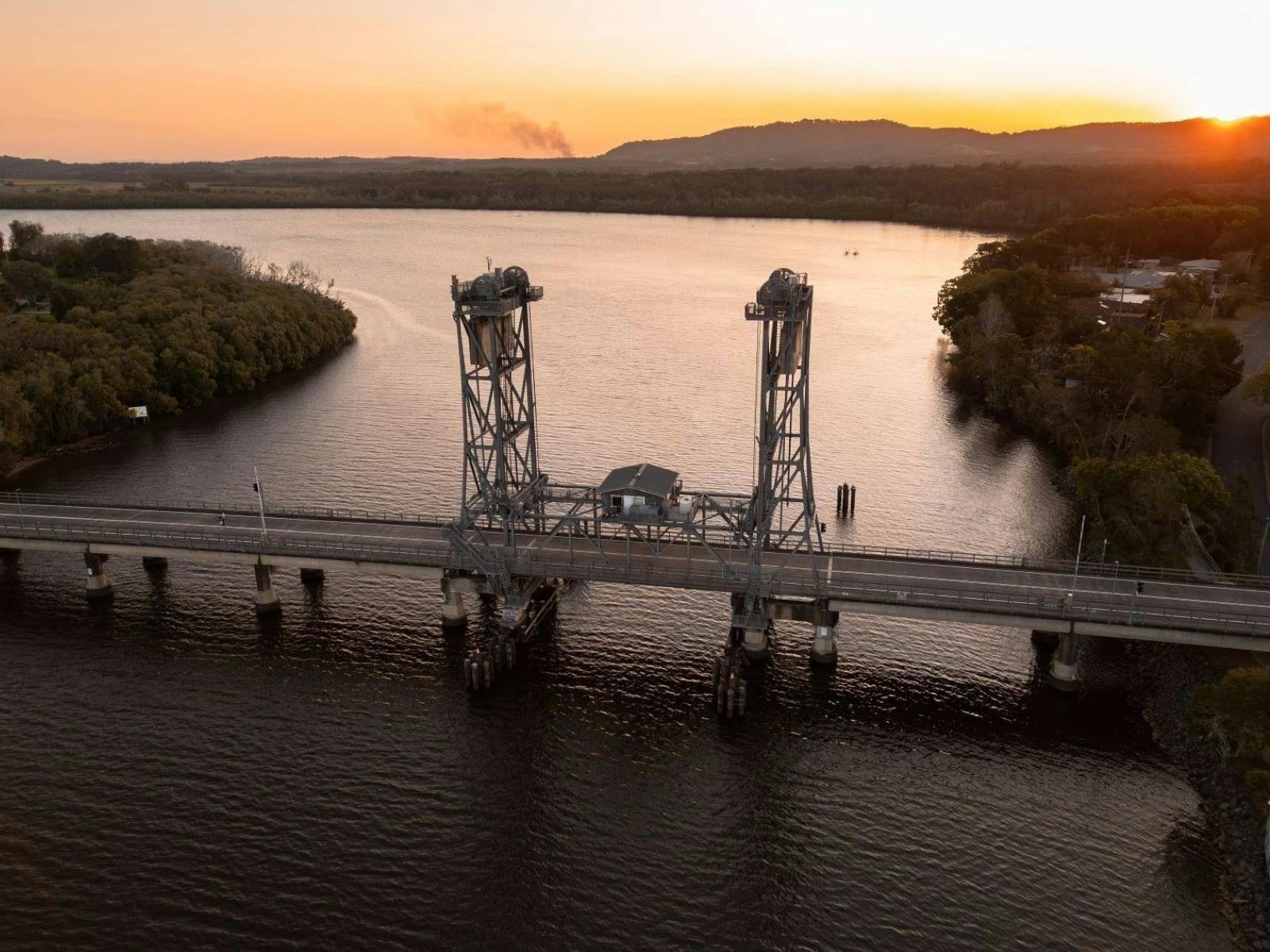 Steel lift bridge over a river at sunset. — North Coast Stock Feeds in Wardell, NSW