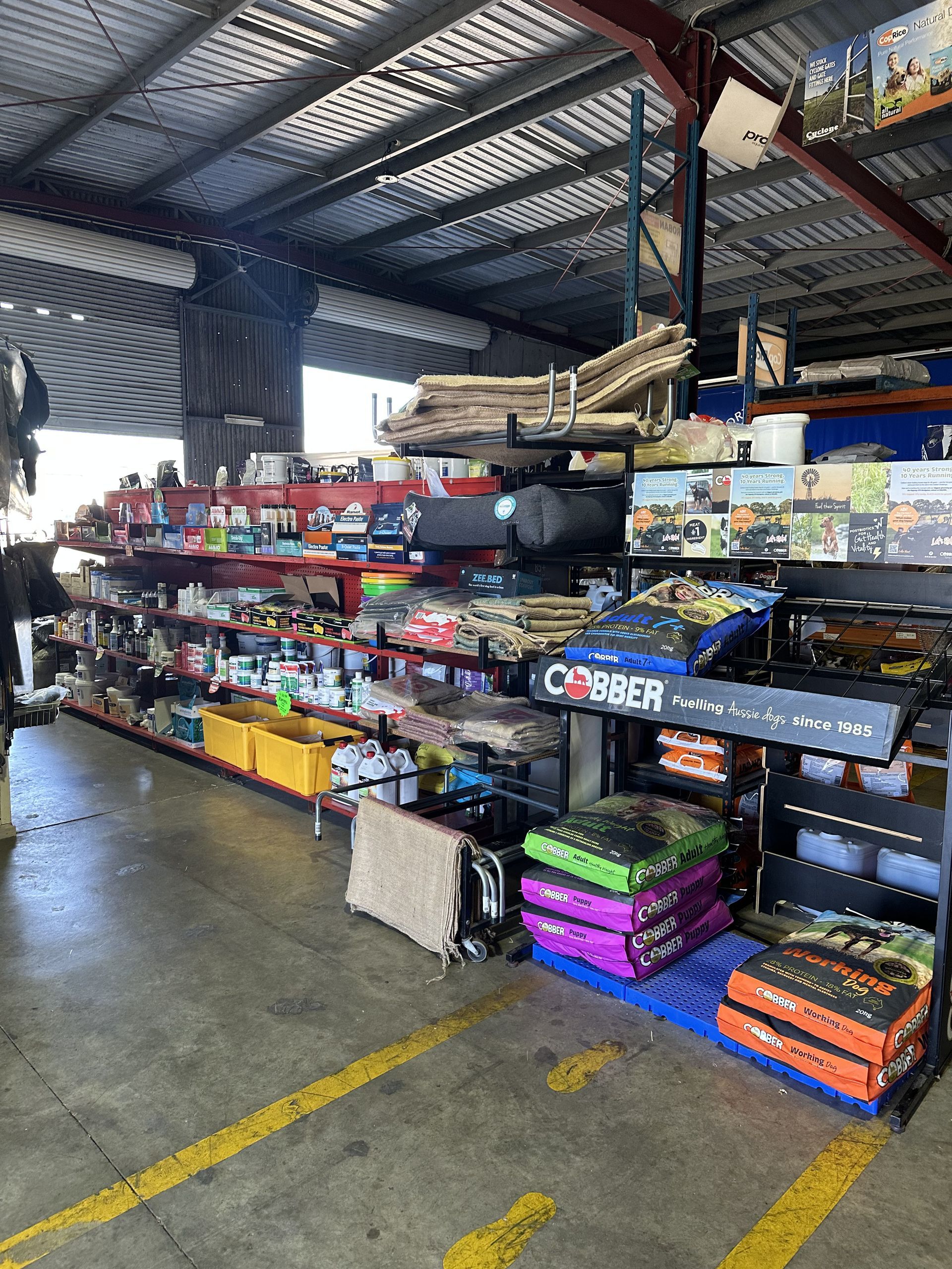Warehouse interior with shelves of merchandise. Yellow lines on floor— North Coast Stock Feeds in Ballina, NSW