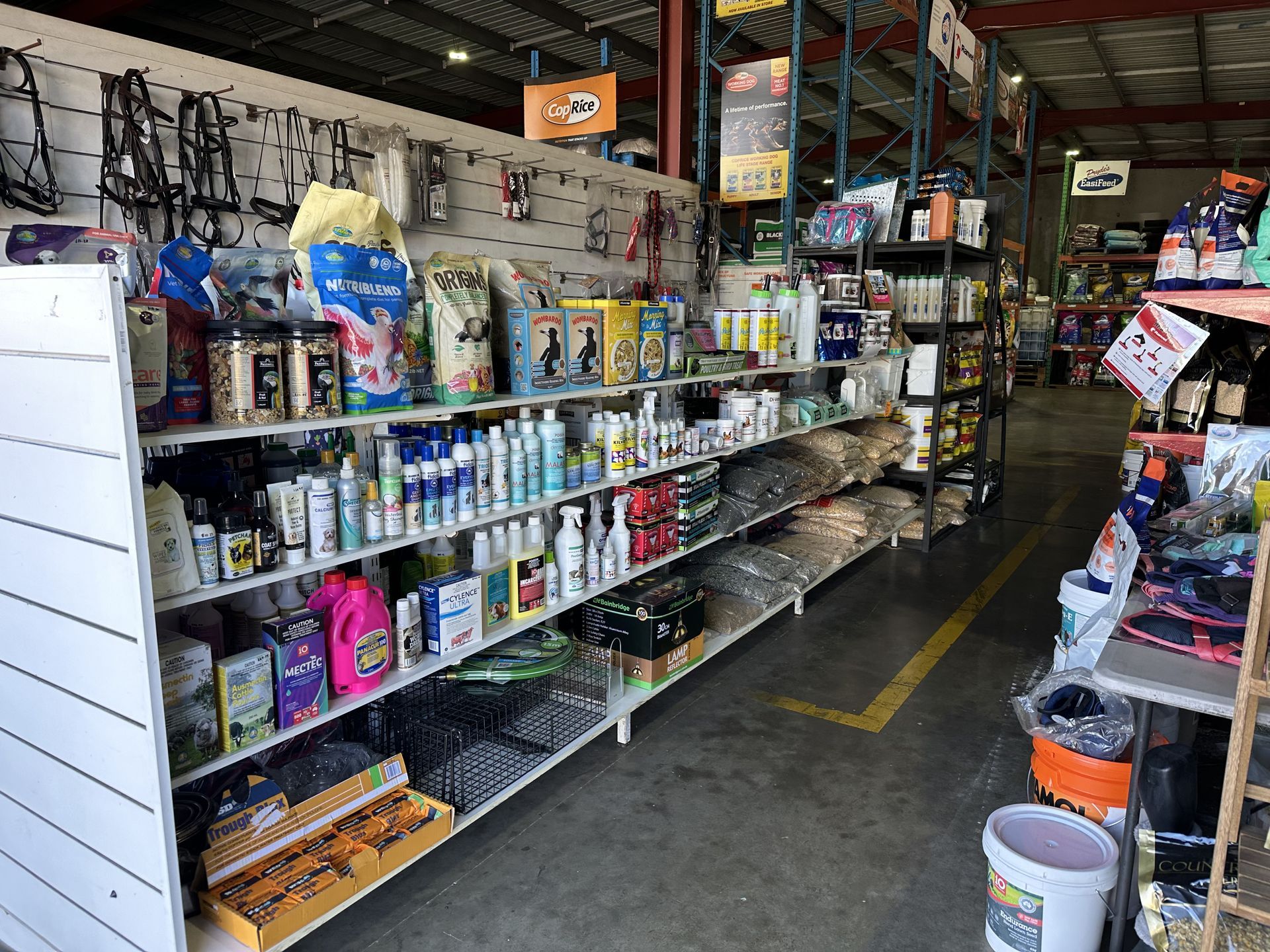 Shelves of various pet supplies in a store. — North Coast Stock Feeds in Wardell, NSW