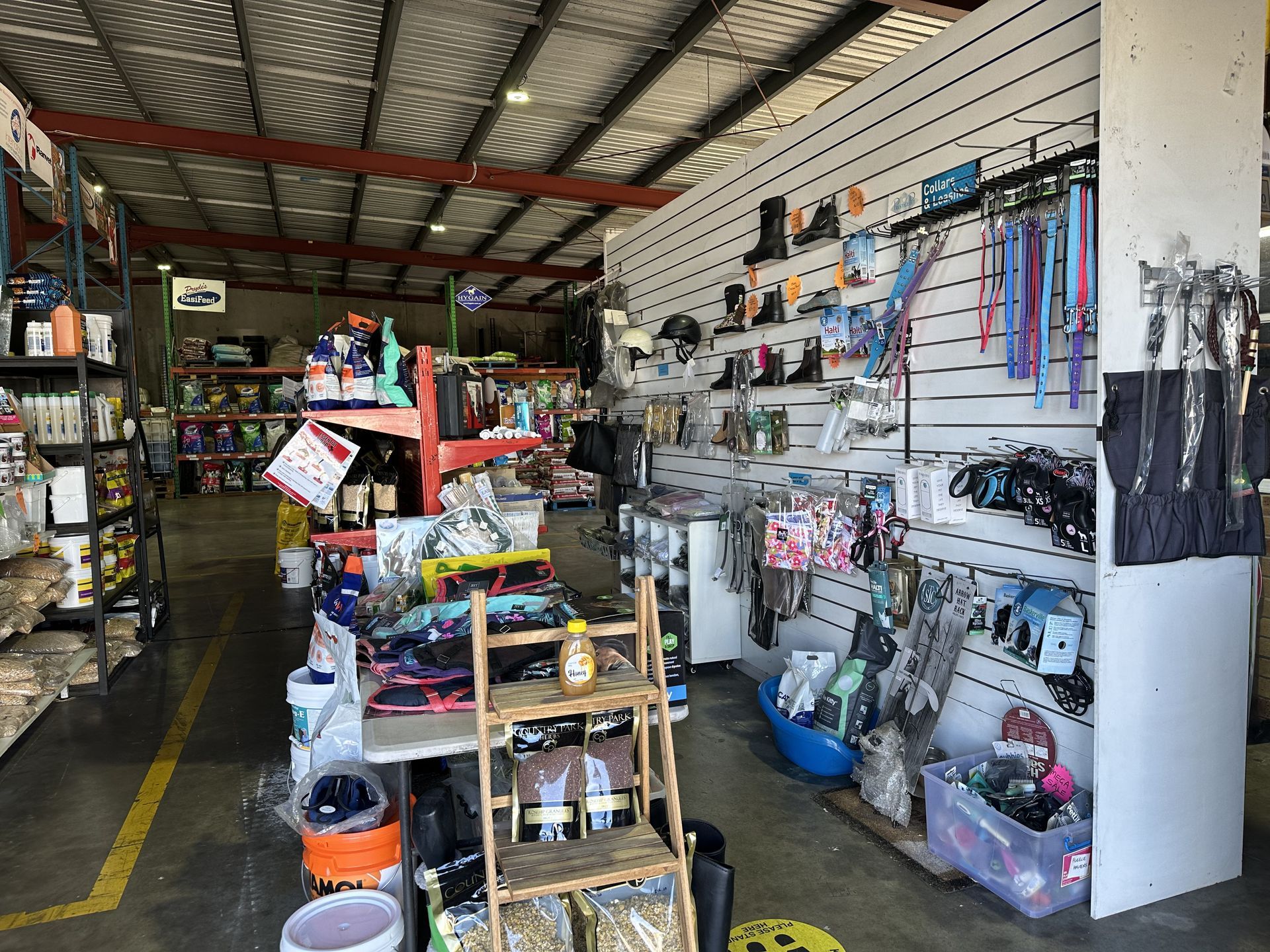 Interior view of a retail pet supply store with various items displayed on shelves and walls. — North Coast Stock Feeds in Wardell, NSW