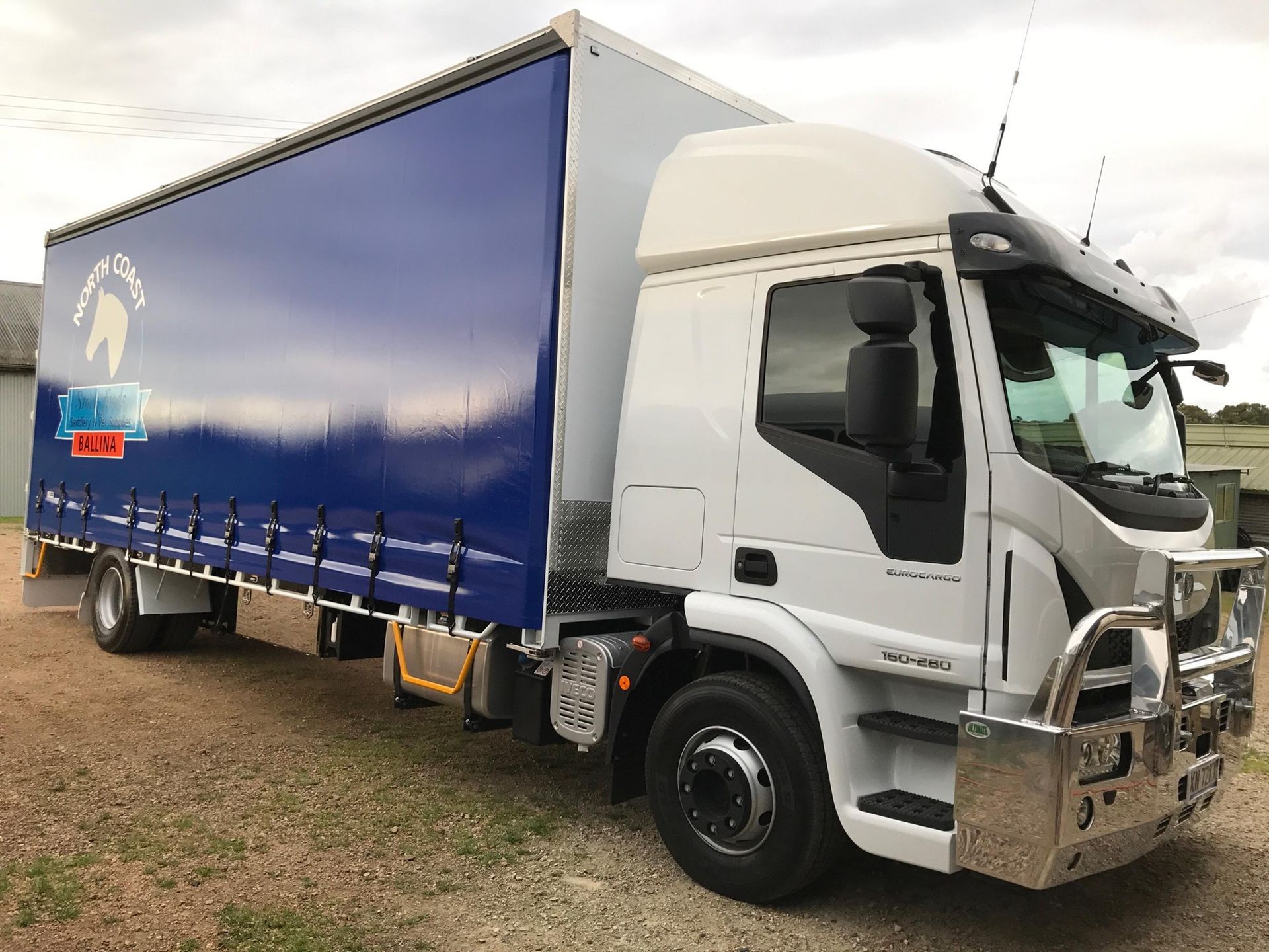 White Truck With a Blue Tarp Trailer — North Coast Stock Feeds in Ballina, NSW