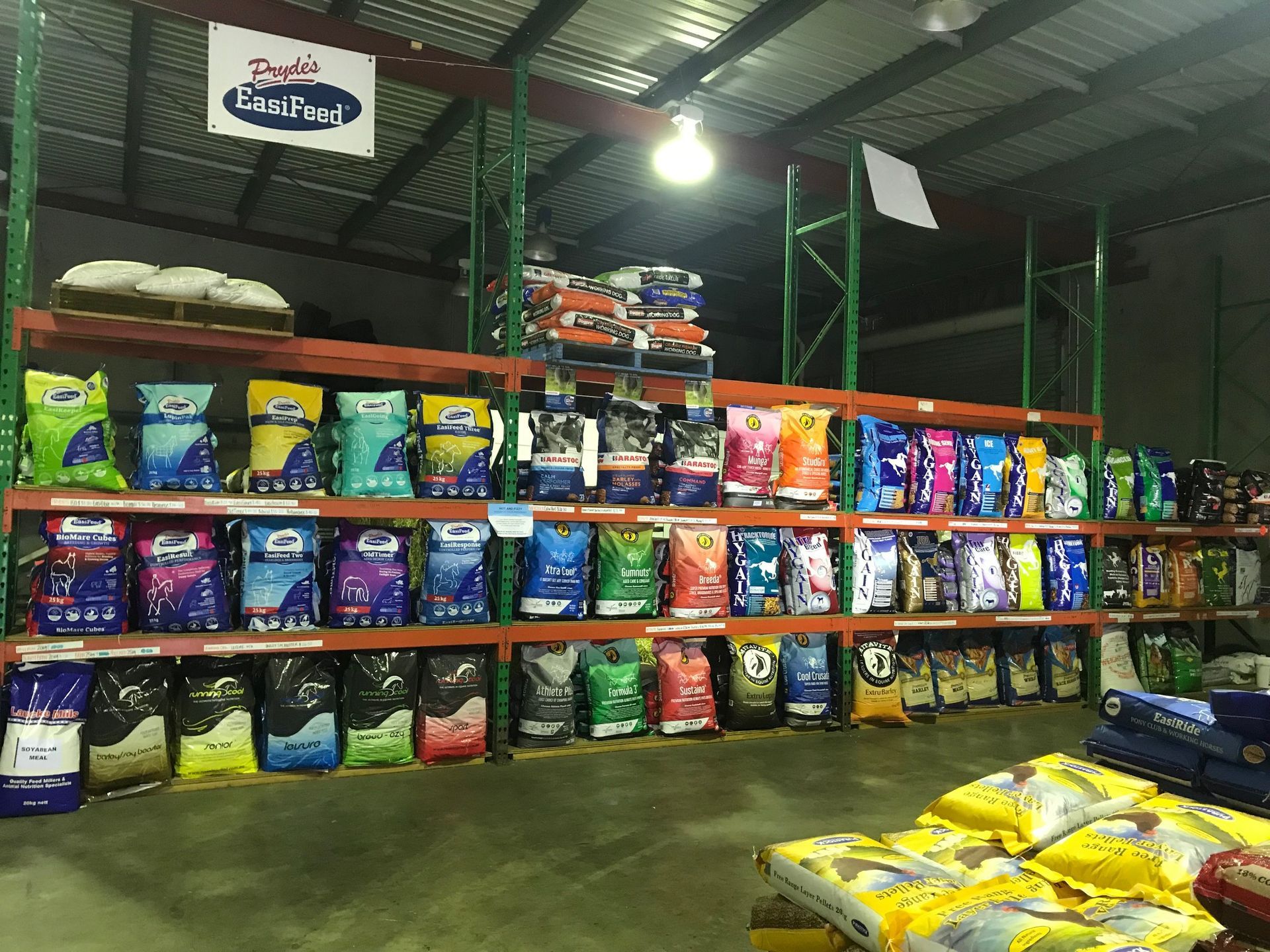 Shelves Stocked With Various Pet Food Bags in a Warehouse Setting — North Coast Stock Feeds in Ballina, NSW