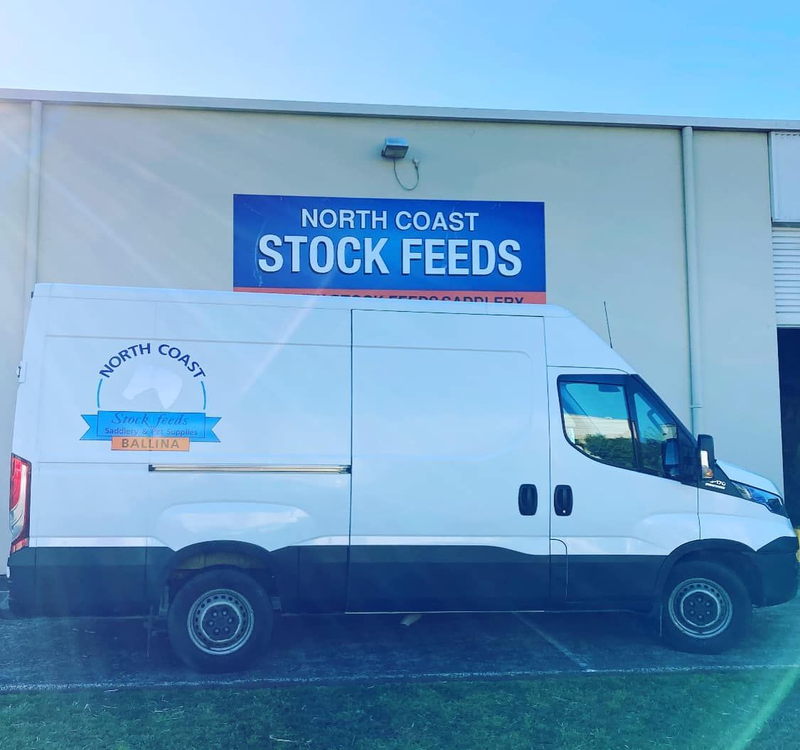 White Van Parked Outside a Building — North Coast Stock Feeds in Ballina, NSW