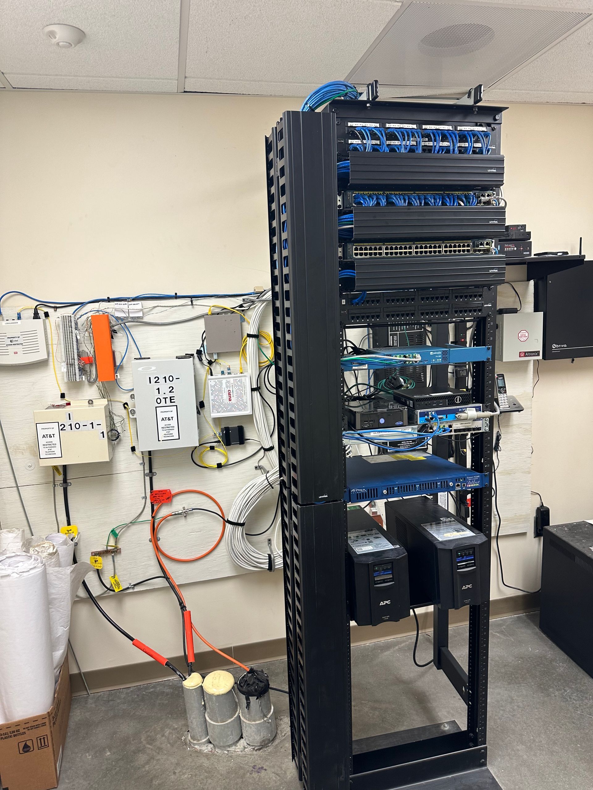 A server rack with a lot of wires coming out of it