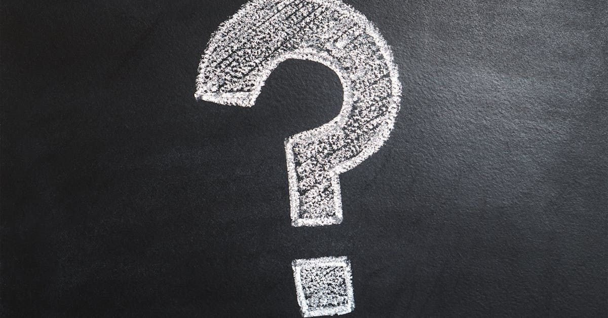 A question mark is written in white chalk on a blackboard.