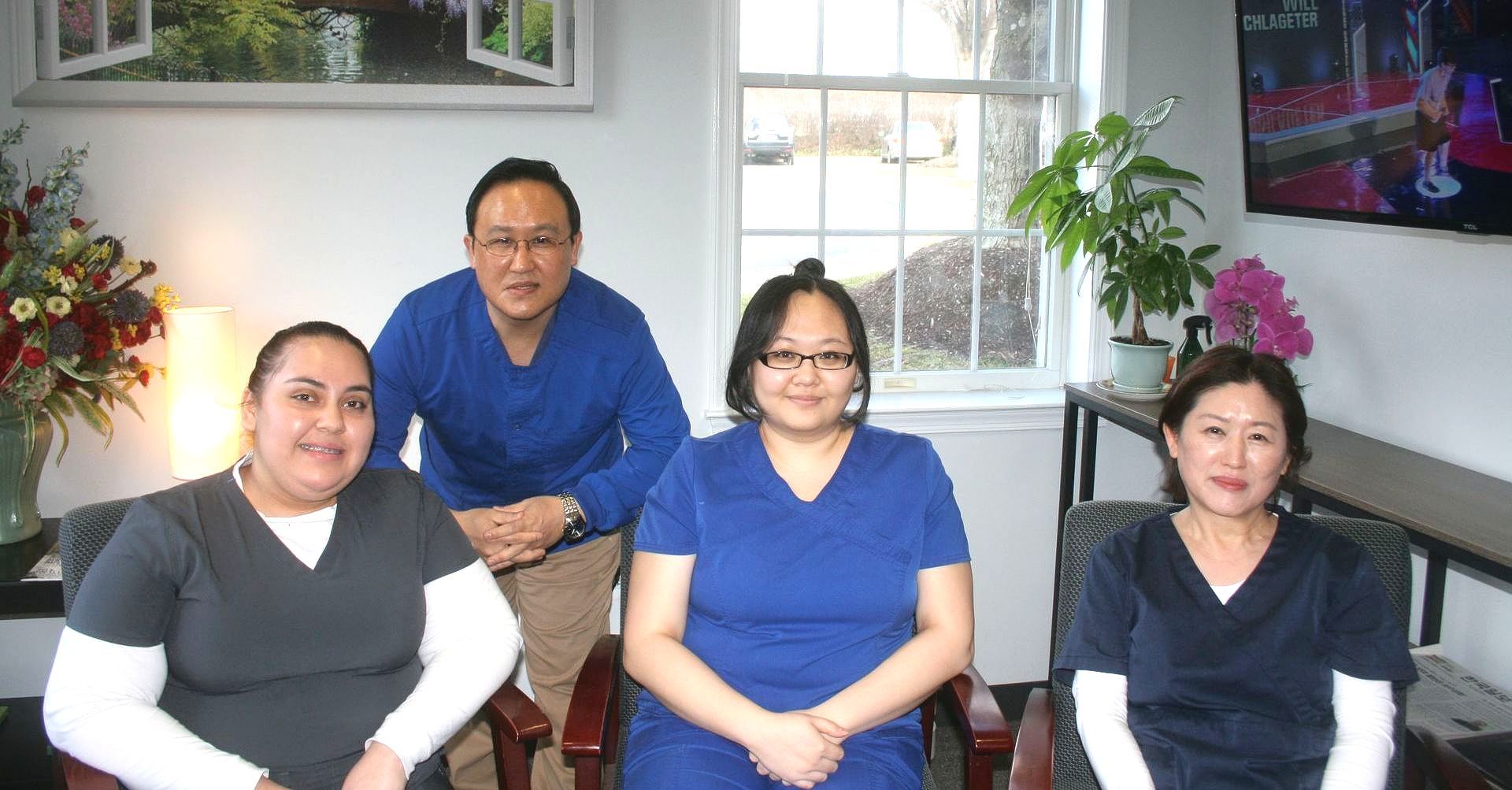 Dr. Cho's Team  posing for a picture in a room.