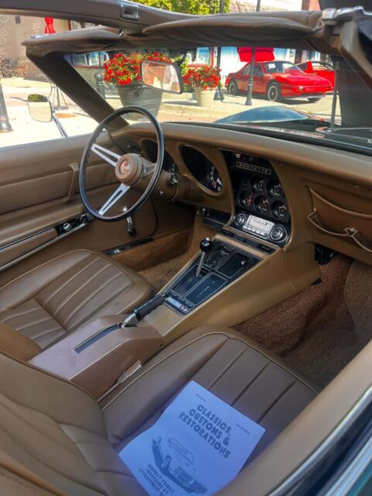 The inside of a car with a guide on the dashboard