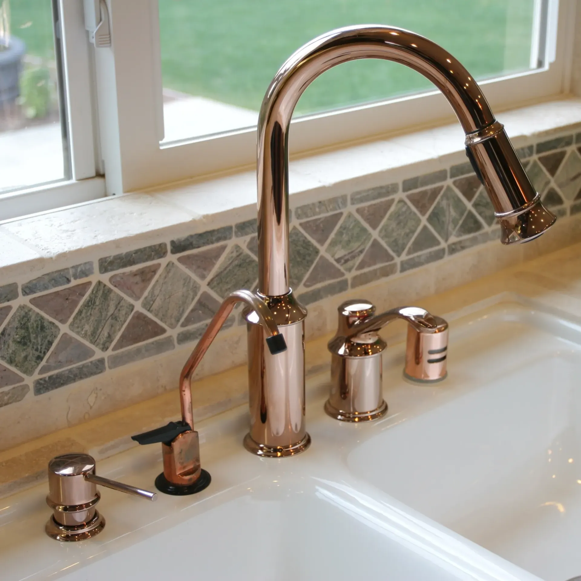 Maese Solutions  Electric  Plumbing  HVAC - A kitchen sink with a copper faucet and soap dispenser