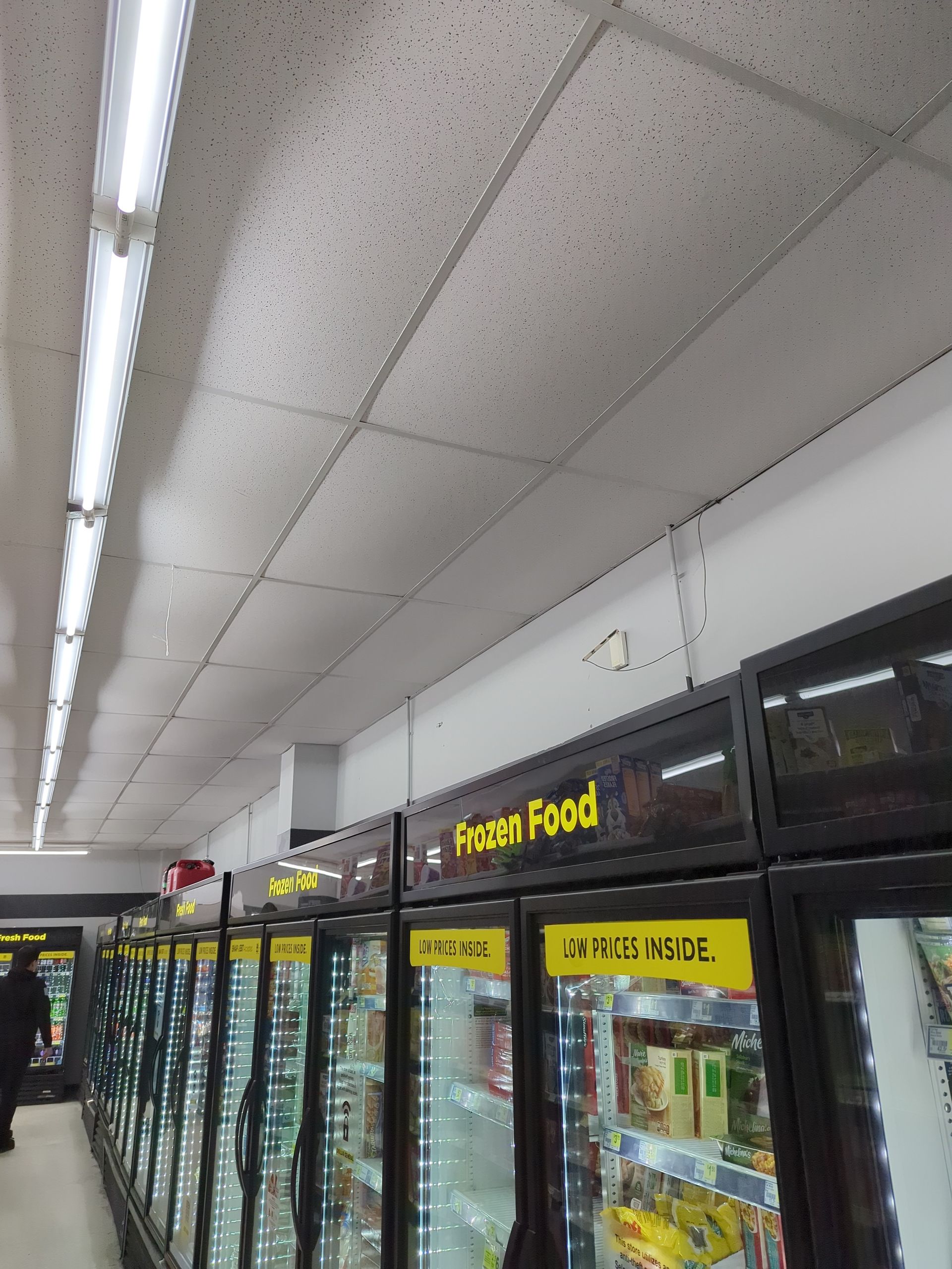A row of refrigerated glass-door cabinets labeled 