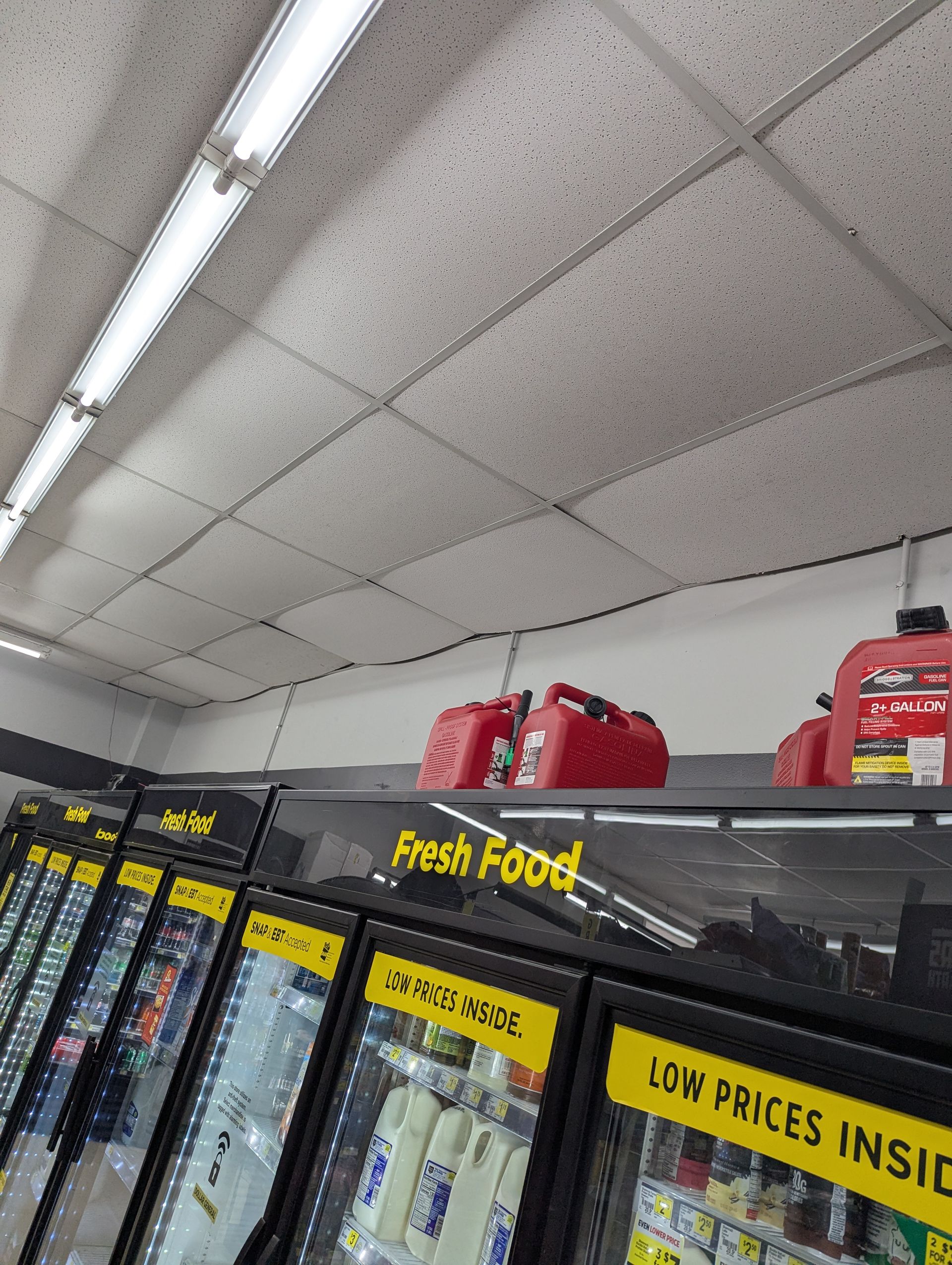 Red gas cans stored on top of a 