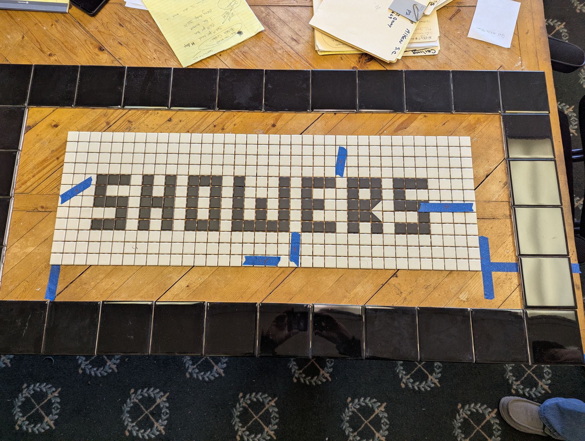 A mosaic sign reading 