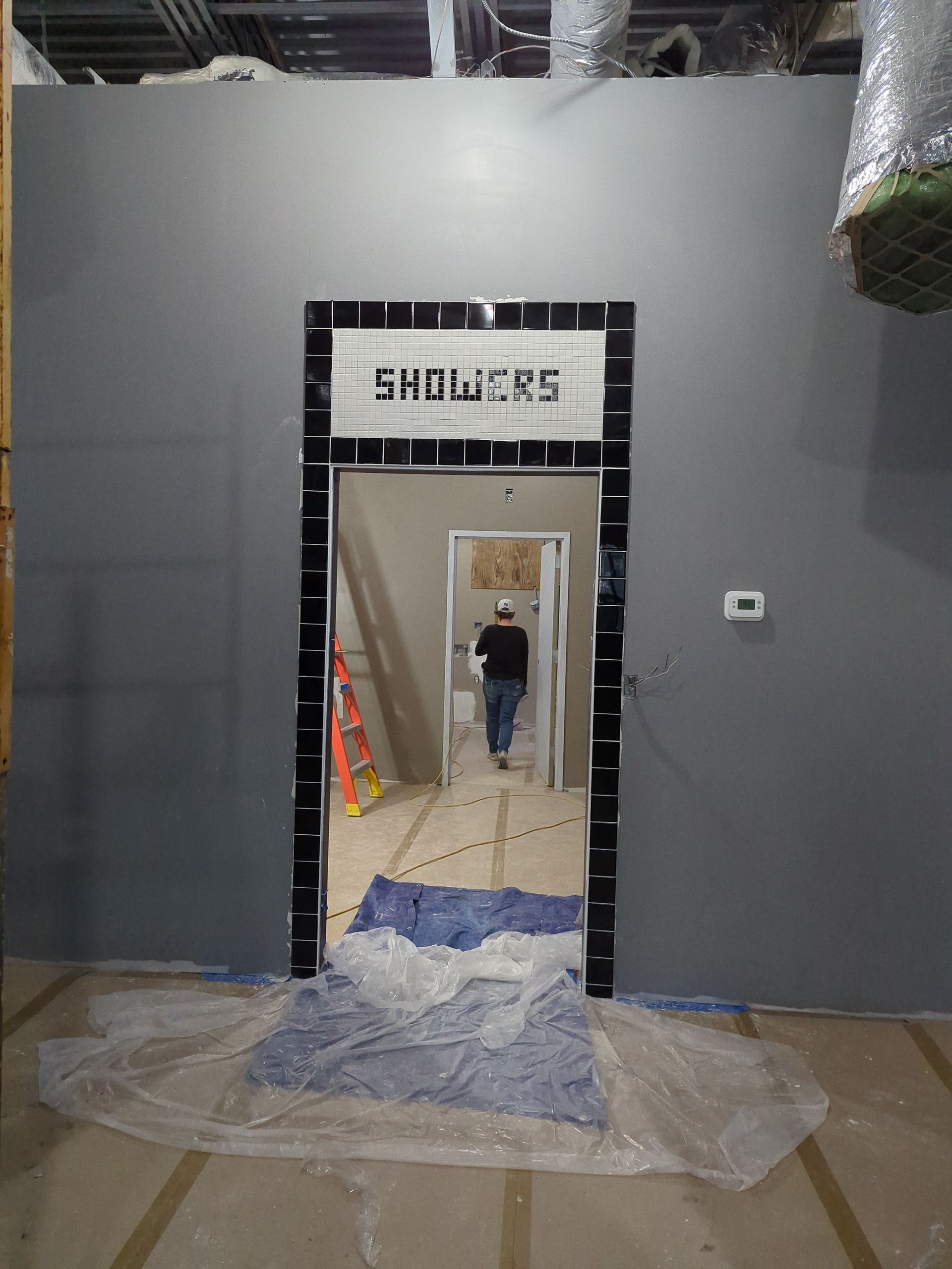 A doorway under construction labeled 