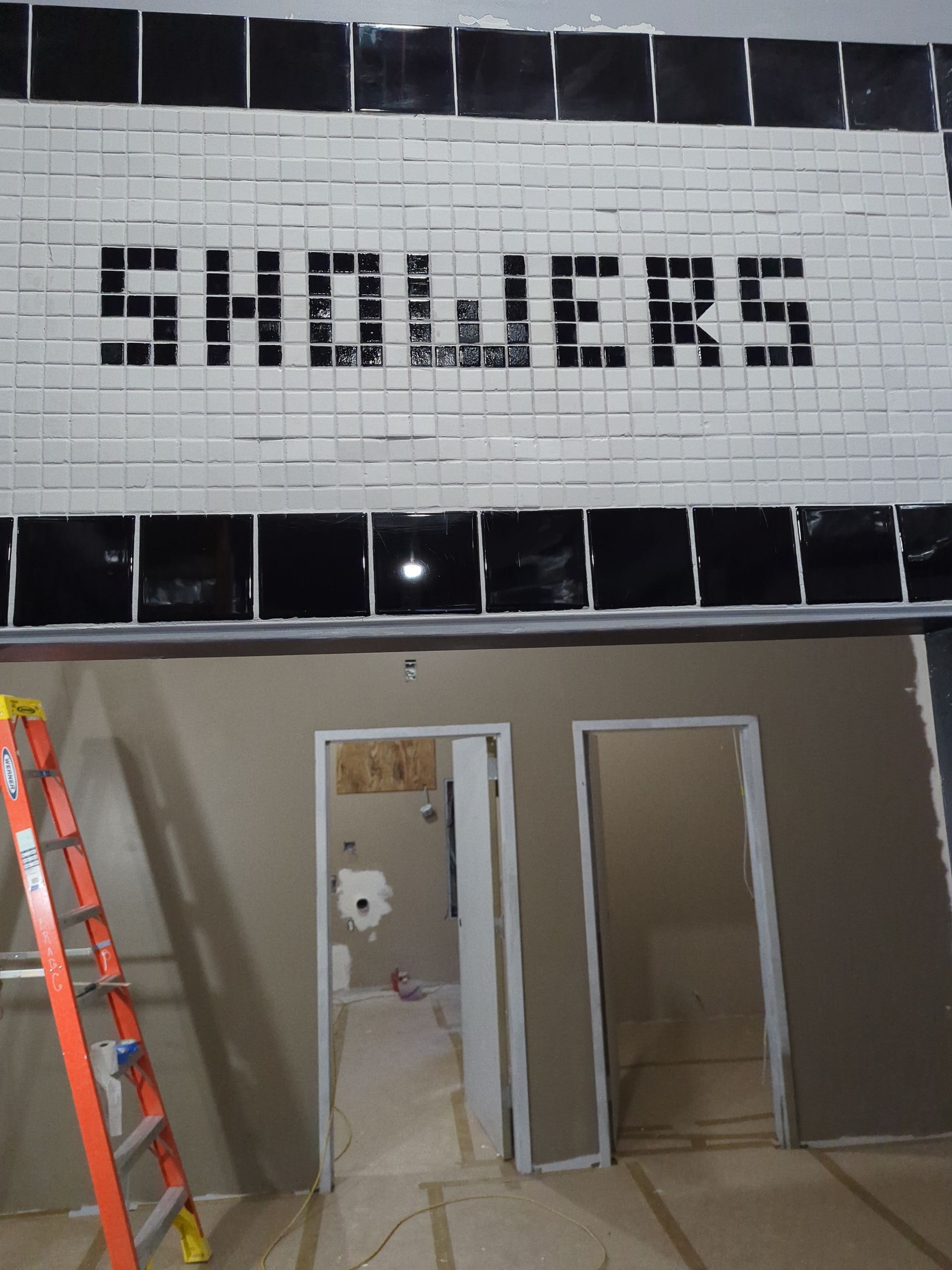 A construction site showing a wall with the word 