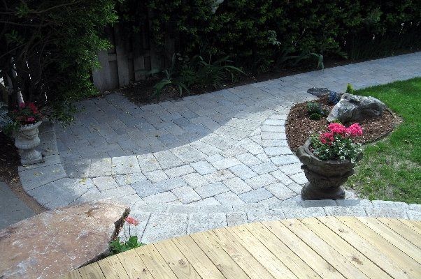 Wooden Area Next To Stone Hardscaped Land With Potted Plants — Virginia Beach, VA — Gentle Rain