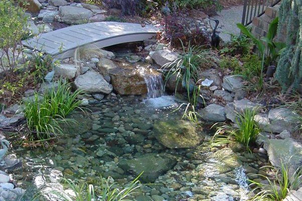 Curved Bridge Next To Flowing Water — Virginia Beach, VA — Gentle Rain