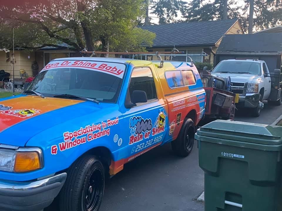 A colorful truck is parked in front of a house.