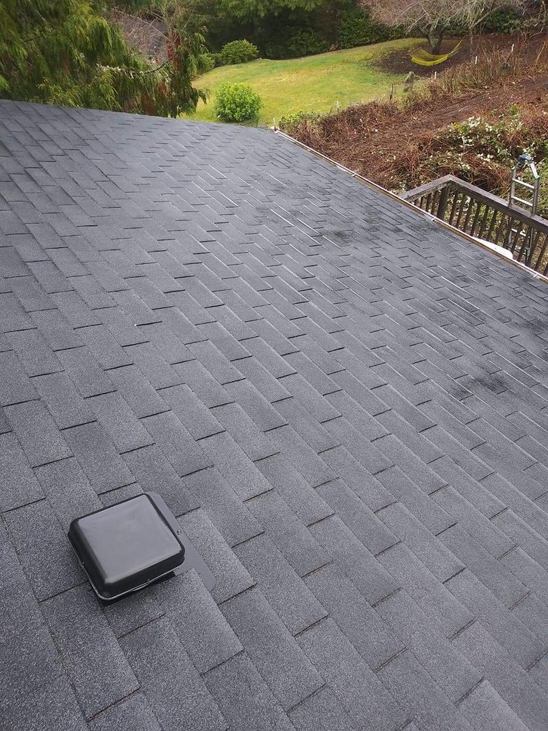 A close up of a roof with a chimney on it.