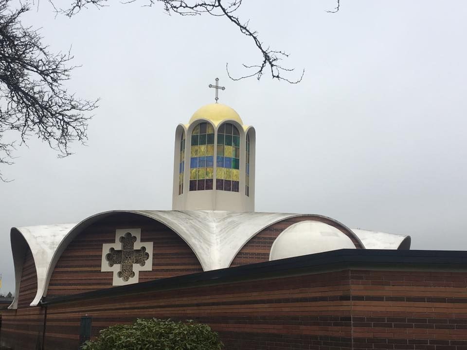 A church with a dome and a cross on top of it.